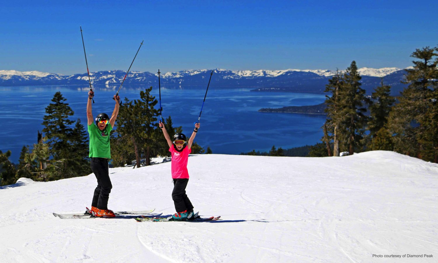 dad and son skiing during the sping in the tahoe lake area e1684215958265