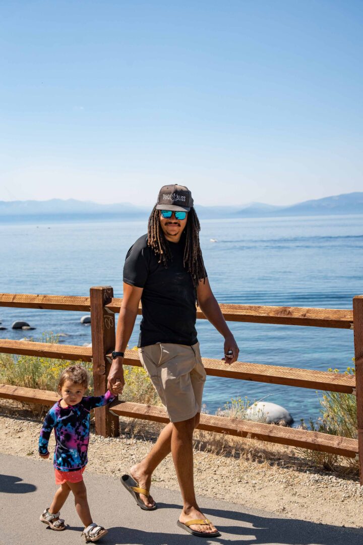 father walking with her daughter on a trail in the tahoe lake