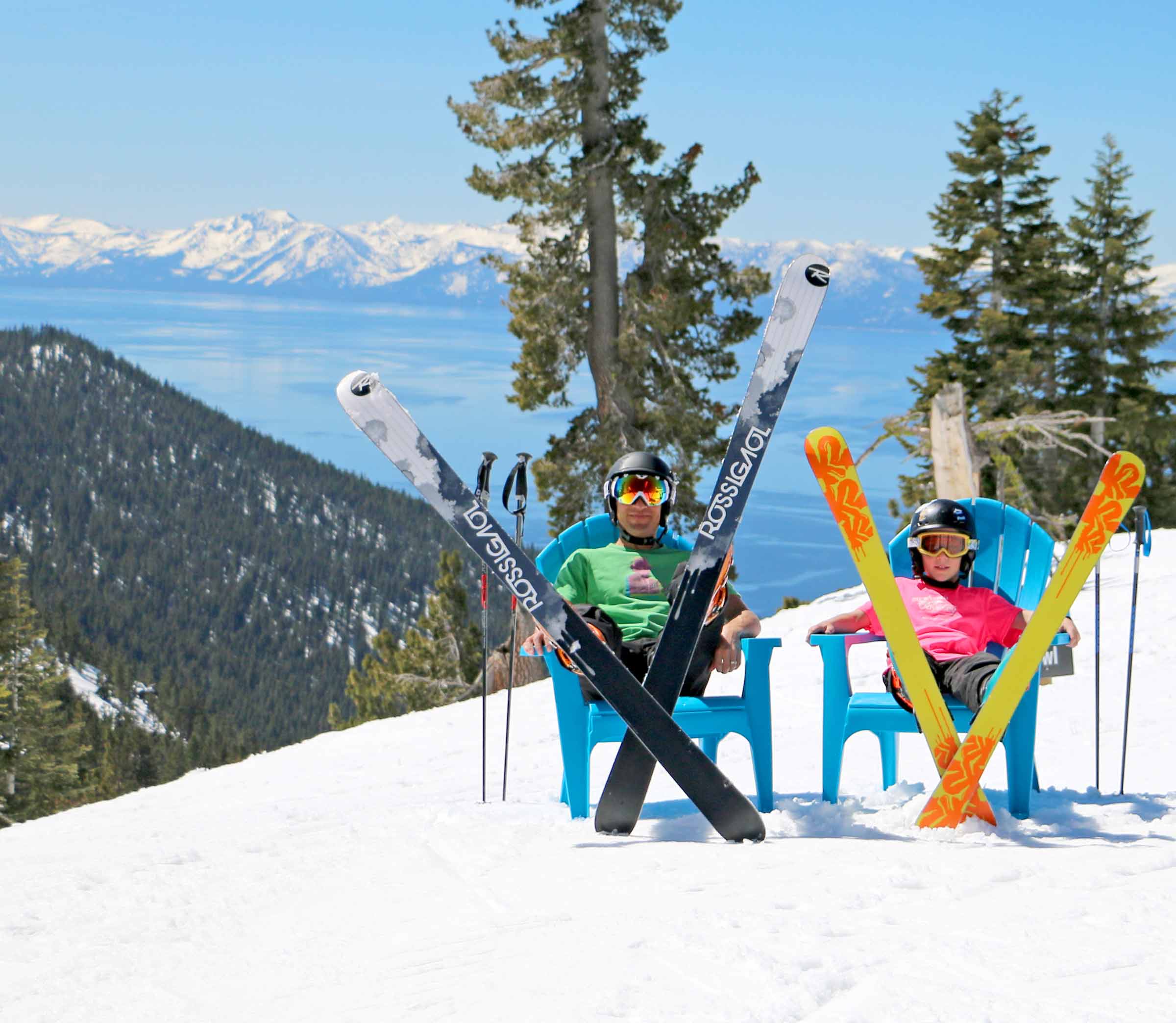 people sitting on chairs in the snow with their skiing gear